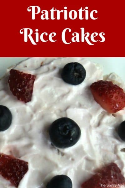 Rice cake covered with yogurt, topped with red and blue berries.