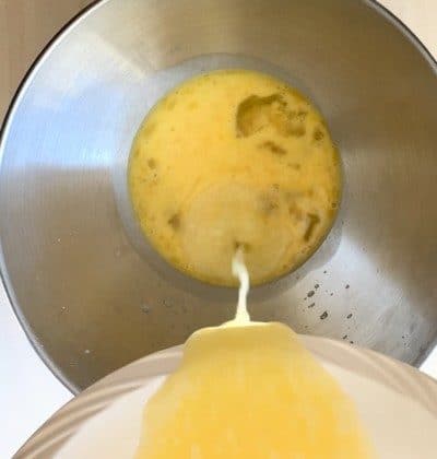 Mixing eggs with buttermilk.
