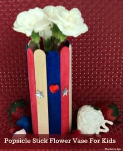 Easy popsicle stick craft for kids! Enjoy the red, white and blue holidays using the dollar store, your garden and recyclable cans and bottles to make these cute little vases.