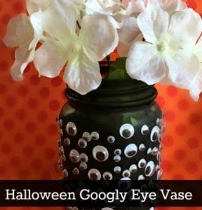 Googly eye vase with white flowers.