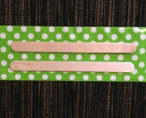 Popsicle sticks on green duct tape.