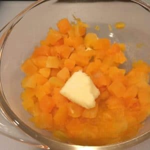 Cooked butternut squash with a pad of butter
