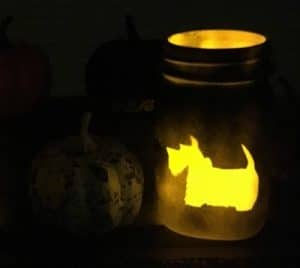 Illuminated mason jar with dog design.