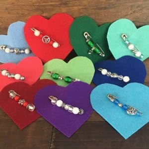 Variety of safety pin broochs on felt hearts