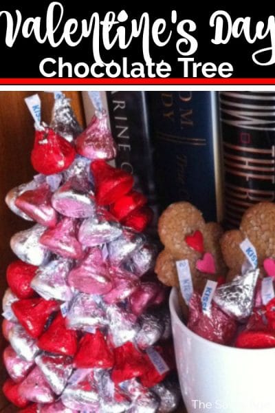 Valentine's Day chocolate tree made of red, pink and white hershey kisses sitting on a bookshelf.