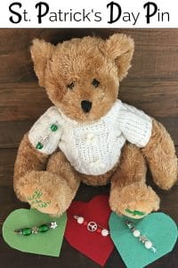 Teddy Bear with safety pin jewelry on sweater.