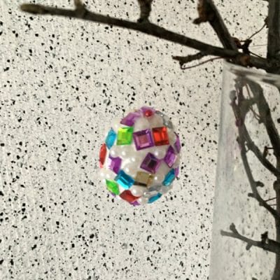 easter egg covered in jewels hanging from tree