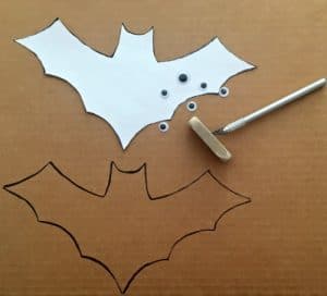 outline of bat on cardboard with exacto blade