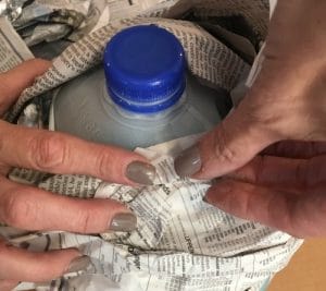 plastic jug covered with newspaper