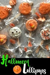 Tray of decorated Halloween lollipops in orange, white and black.