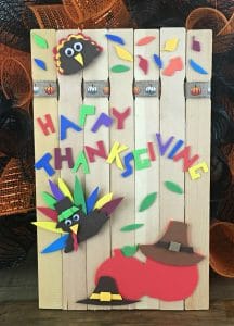 Paint stick turkey craft: paint stick background decorated with paper turkey, owl and leaves.