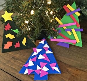 3 painted cardboard tree ornaments decorated with foam paper ornaments.
