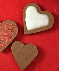Fudge hearts decorated with with frosting and plain.