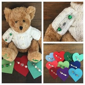 Teddy Bear in Irish sweater with pin made from a safety pin and green beads.