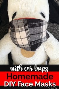 Stuffed Snoopy wearing a homemade plaid face mask.