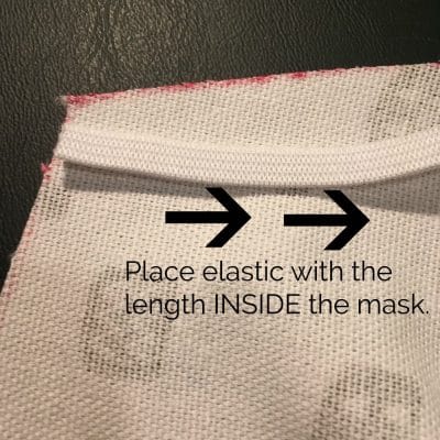 Inside of mask with white elastic laying flat.