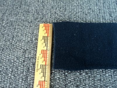 Black sock with top measured at 3 inches by a ruler.