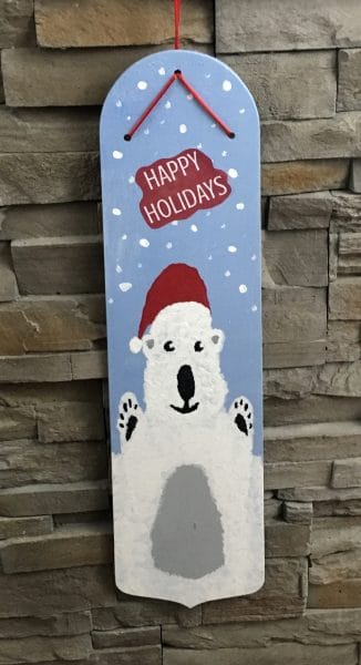 Recycled Fan Blade made into a Christmas Wall hanging. white polar bear with santa hat with Happy Holidays.